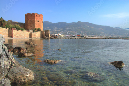 Landscape with a red tower in the bay of Alanya.