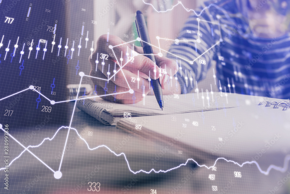 Financial forex graph drawn over hands taking notes background. Concept of research. Double exposure Financial forex graph drawn over hands taking notes background. Concept of research. Double exposure