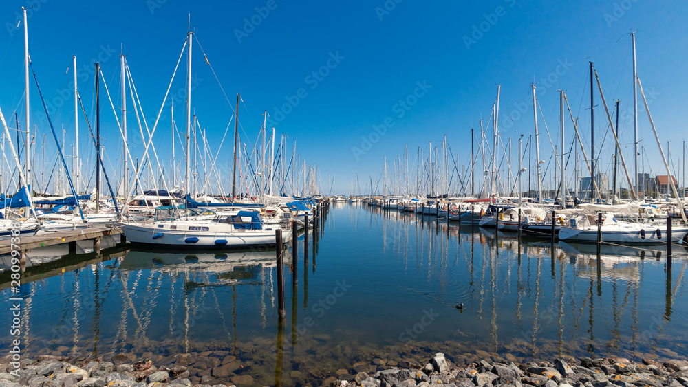 Harbor with many white sailing yachts in beautiful summer weather. Heiligenhafen, Germany