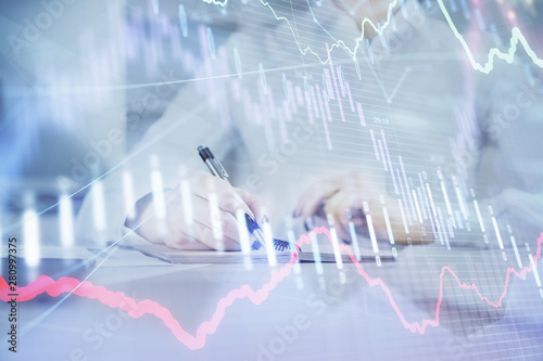 Financial chart drawn over hands taking notes background. Concept of research. Multi exposure © peshkova