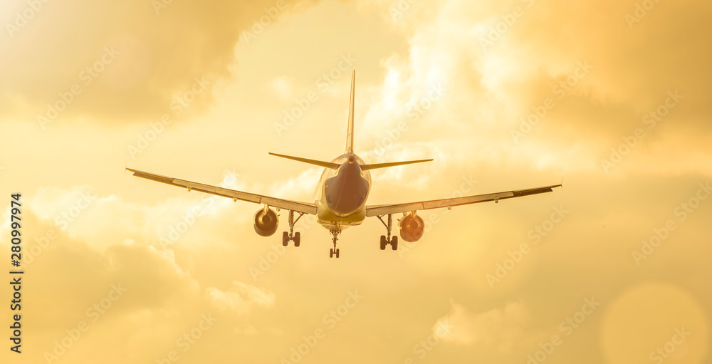 plane flies in sky with clouds in sunlight. plane flies in sky with clouds in sunlight.