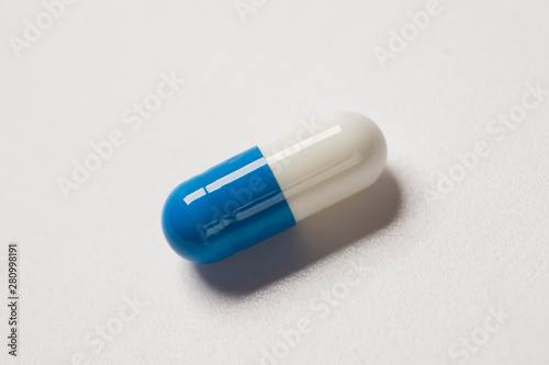 Single capsule pill isolated on white background