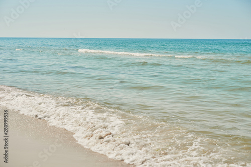 View of beach and sea, blue water. Tourism and vacation on ocean. Family vacation in summer. Vacation at sea . Summer travel.