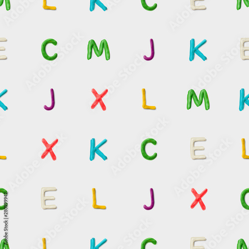 Seamless pattern with alphabet. Handmade modeling clay letters. Realistic 3d vector lettering background.
