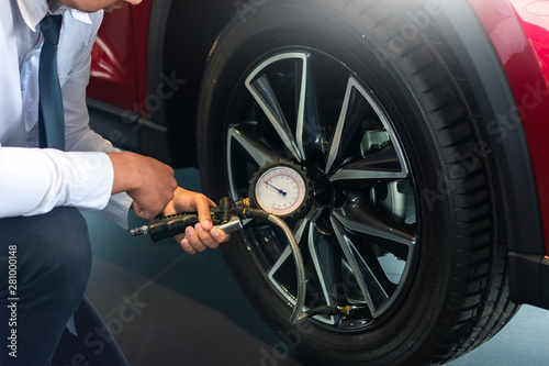 Wallpaper Mural Asian man car inspection holdind tablet for Measure quantity Inflated Rubber tires car.Close up hand holding machine Inflated pressure gauge for car tyre pressure measurement for automotive automobile Torontodigital.ca