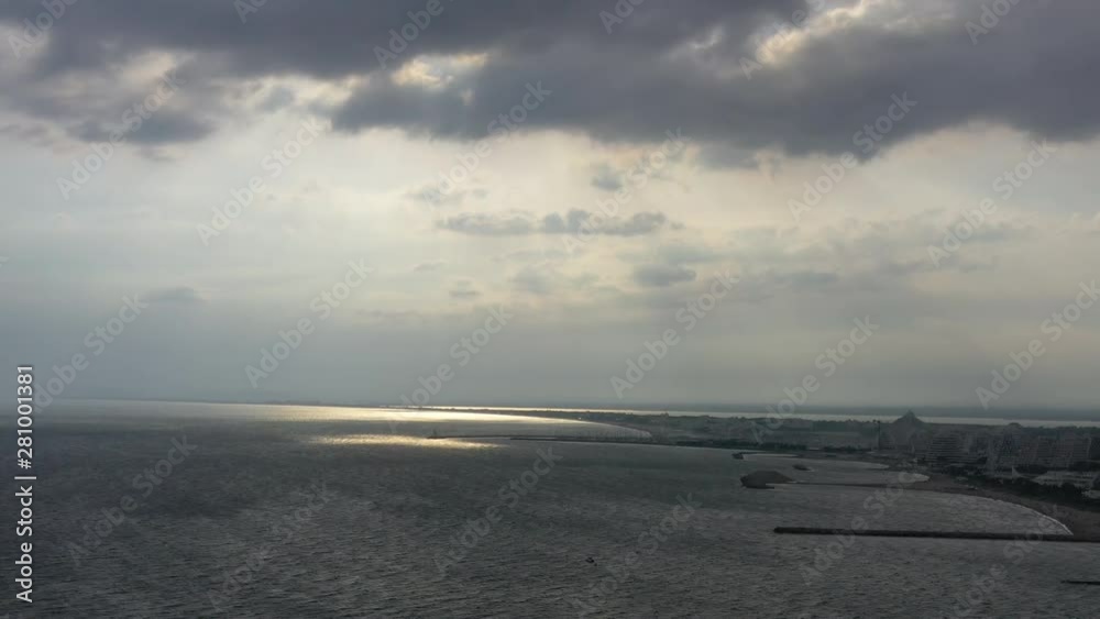 Stormy sunset over la Grande Motte seaside resort France aerial view over the mediterranean sea coastline Stormy sunset over la Grande Motte seaside resort France aerial view over the mediterranean sea coastline