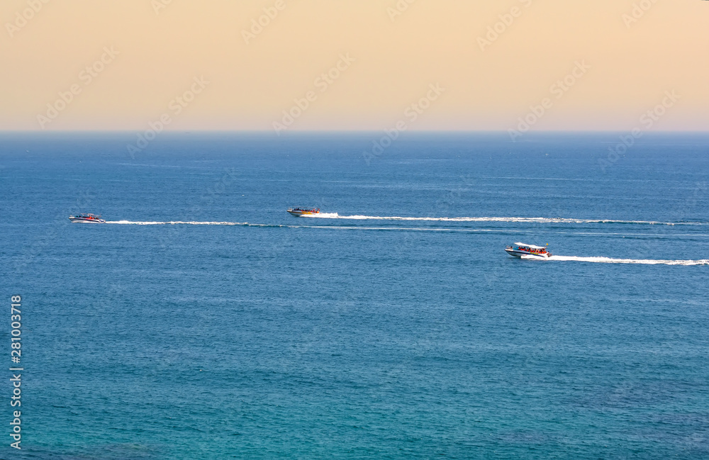 The speed boat fast surfing on blue sea bay