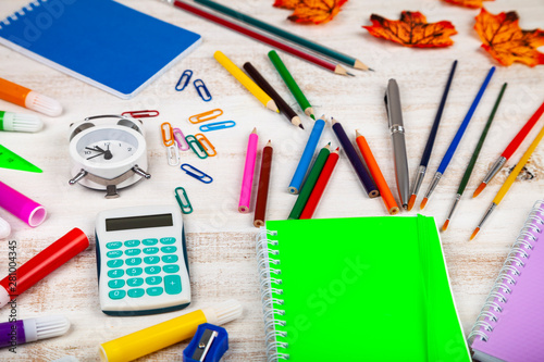 Items for the school on a wooden table.