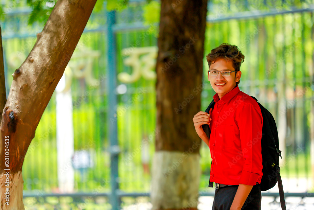 Obraz premium Indian college boy with Holding bag 