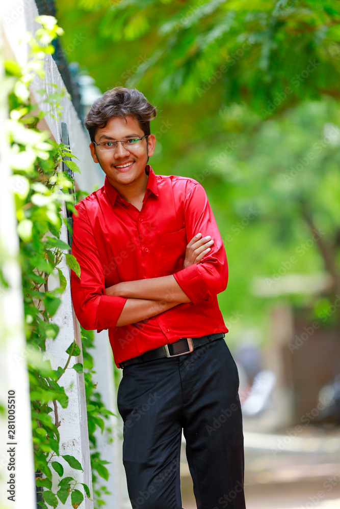 Indian / Asian Collage boy in red shirt and wearing spectacles Indian / Asian Collage boy in red shirt and wearing spectacles