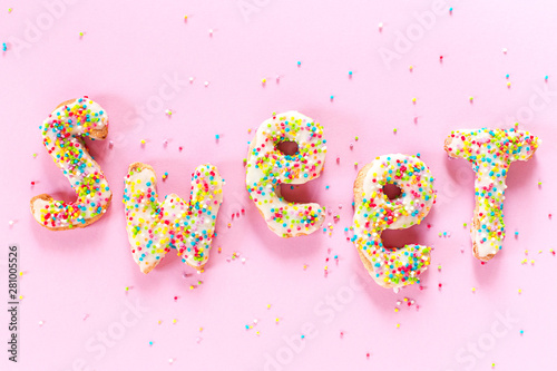Pink background with letters icing sweet from cookie