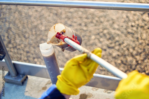 Worker takes samples from the septic tank