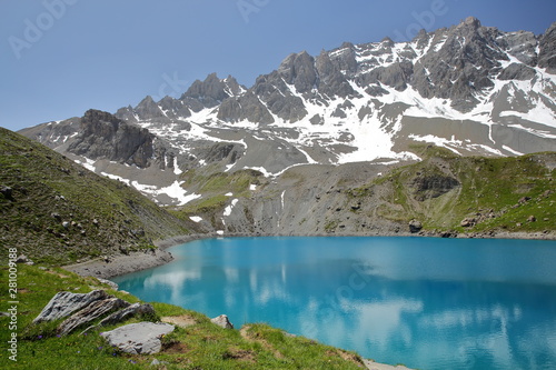Fototapeta Naklejka Na Ścianę i Meble -  Sainte Anne lake located above Ceillac village after two hours hike, with reflections of mountain range covered with snow, Queyras Regional Natural Park, Southern Alps, France