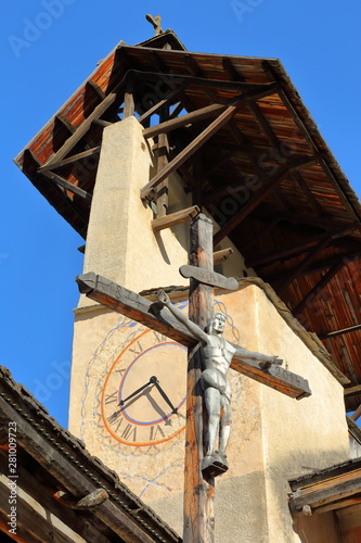 Close-up on the bell tower of Saint Sebastien Church with the Cross of Jesus Christ, Ceillac, Queyras Regional Natural Park, Southern Alps, France photo