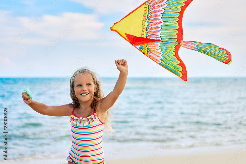 Happy little girl with flying kite on tropical beach Stock Photo ...