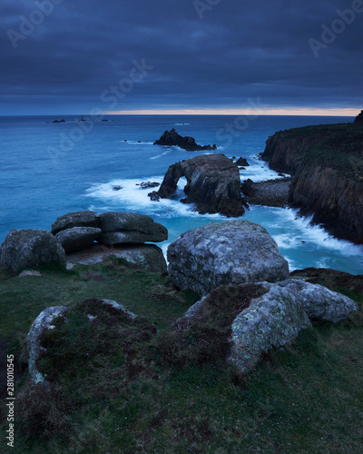 Sunset at Land's End over Enys Dodman rock arch, Longships Lighthouse, Cornwall photo