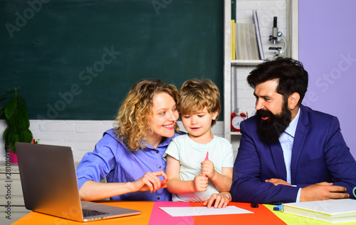 Pupil learning letters and numbers. Education concept. Little boy and his parents. Mother father and son together schooling. Teachers day. Education for kids out of school. Boy from elementary school.