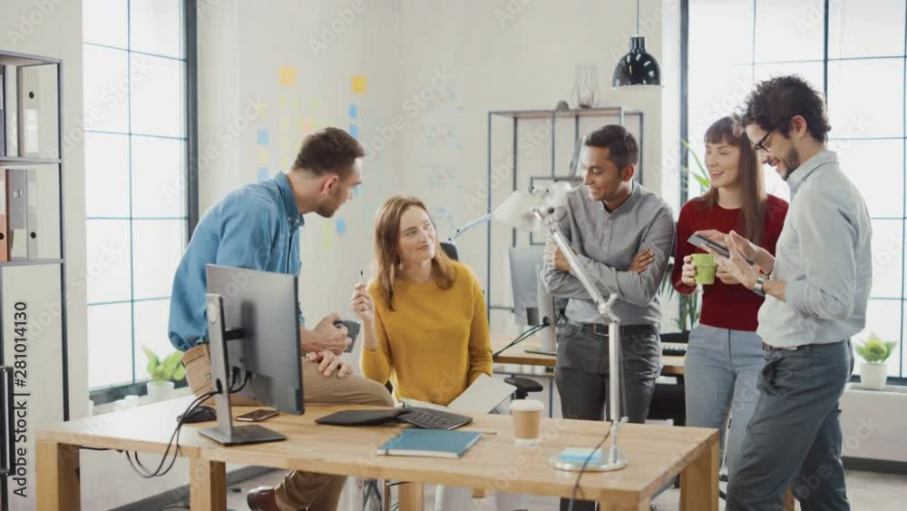 In the Stylish Office: Diverse Group of Business Colleagues Have Meeting. Multi Ethnic Team of Businesspeople Use Desktop Computer, Chat and Watch Videos, Discuss Startup Statistical Growth Strategy