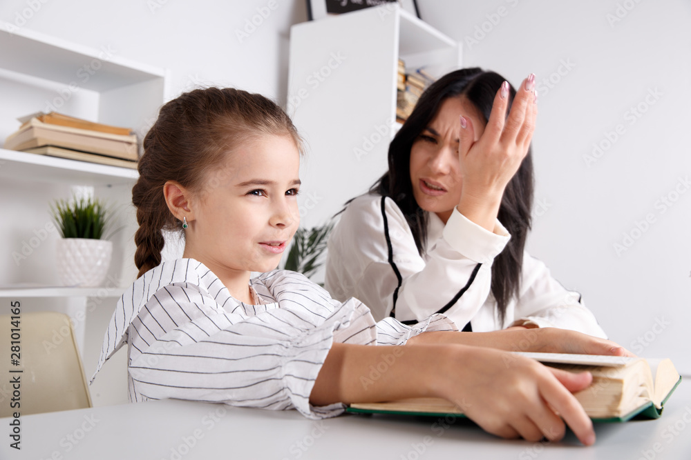 Mom and daughter getting knowledge together sitting at home