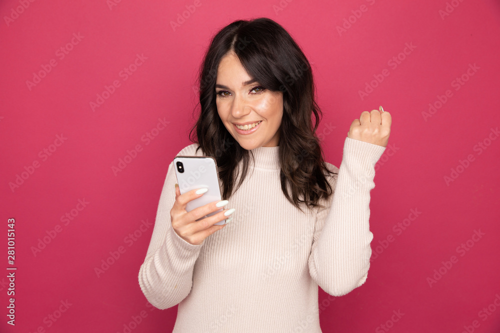 Woman with happy face holding phone and getting good news isolated Woman with happy face holding phone and getting good news isolated