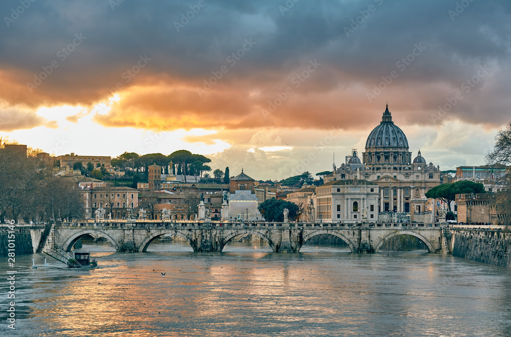St. Peter's cathedral and Tiber river with high water at evening with dramatic sunset sky. Saint Peter Basilica in Vatican city with Saint Angelo Bridge in Rome, Italy
