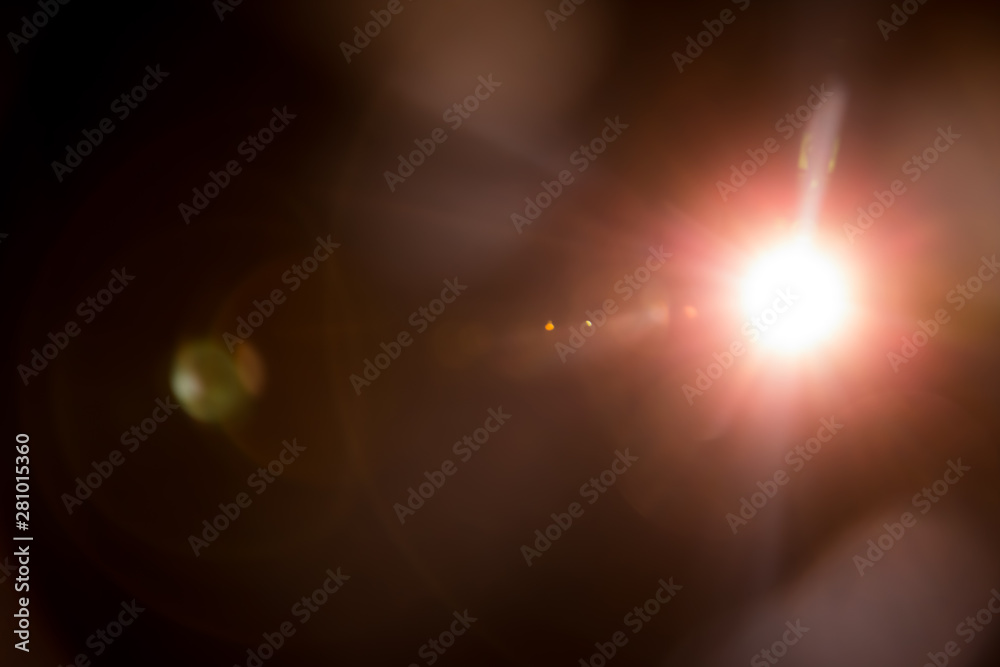 Fototapeta premium Abstract Natural Sun flare on the black background.