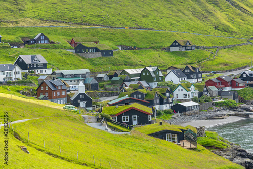 Bour village. Typical grass-roof houses and green mountains. Vagar island, Faroe Islands. Denmark. Europe. photo