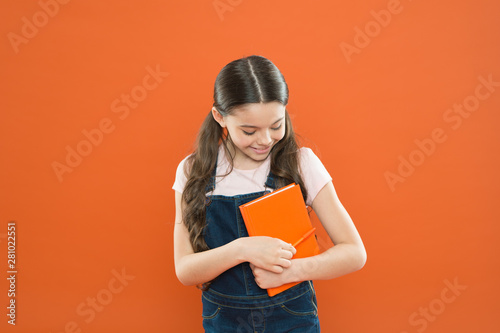 Study at school. First day at school. Ready for first lesson. September is here. Back to school. Child hold book. Interesting literature. Development and education. Child care and happy childhood