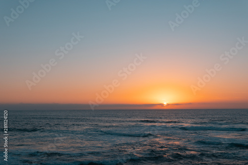 Sunset on sea or ocean. Wavy surface. Horizon line. Relaxation, vacation concept