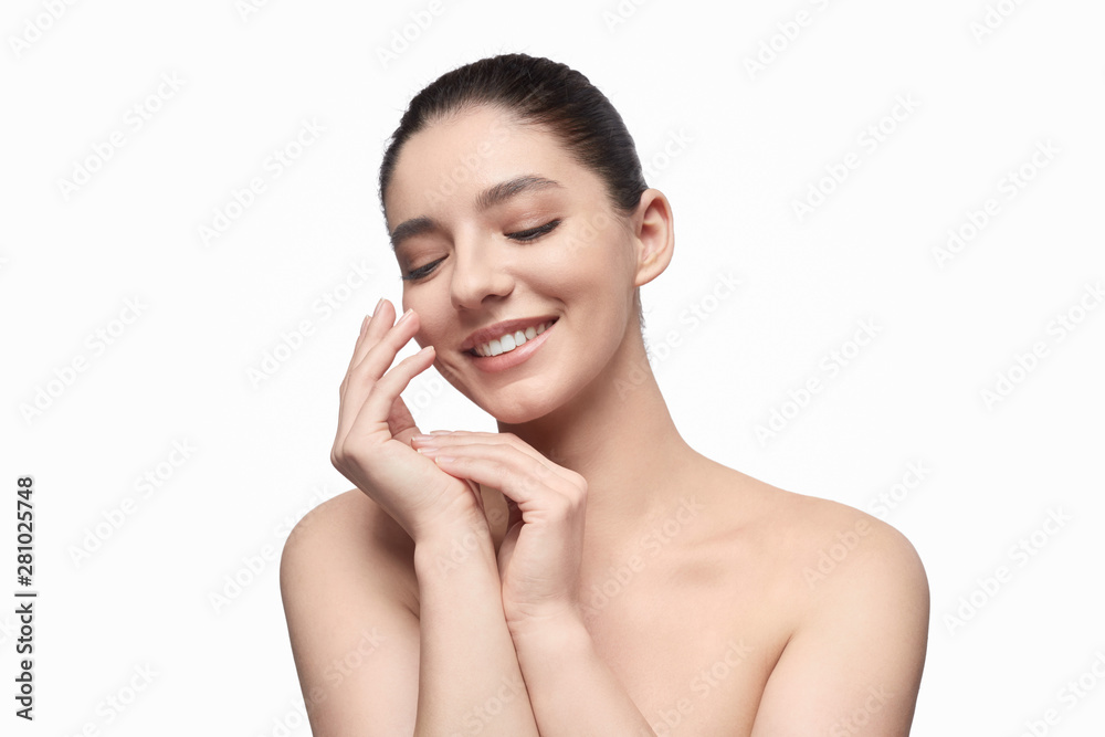 Smiling model smearing cream on hands