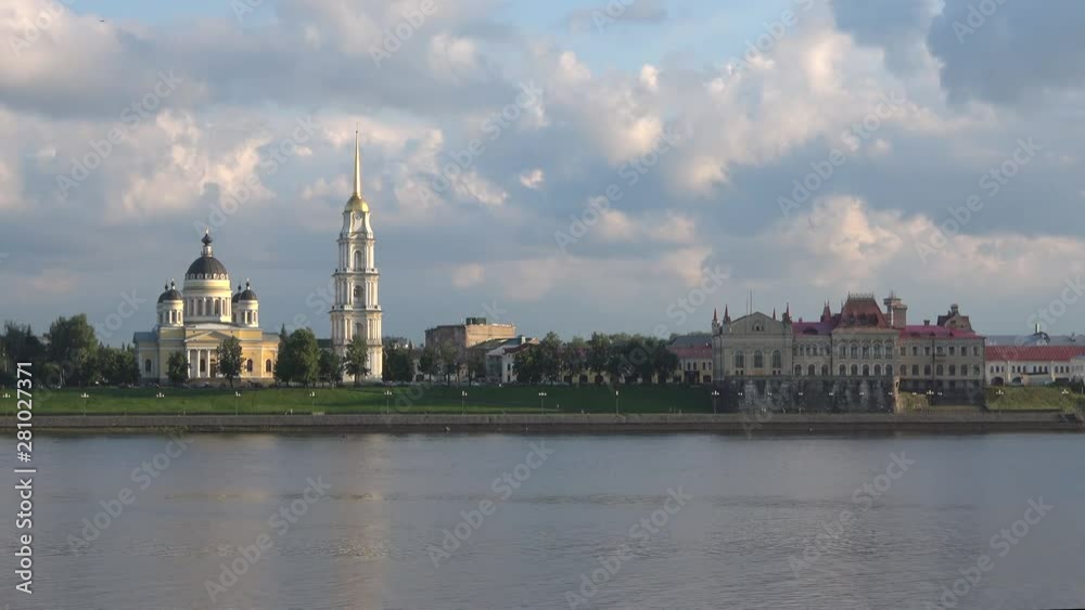View of the old Spaso-Preobrazhensky Cathedral and the old building of the Grain exchange on the Volga embankment on a cloudy July day. Rybinsk, Russia View of the old Spaso-Preobrazhensky Cathedral and the old building of the Grain exchange on the Volga embankment on a cloudy July day. Rybinsk, Russia