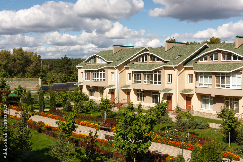 A row of new houses in a suburban village on a sunny day. Russia