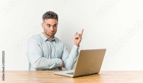 Young handsome man working with his laptop having some great idea, concept of creativity.