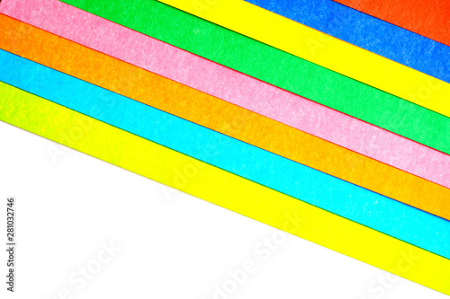 multicolored stripes at an angle from paperboard on white background, top view