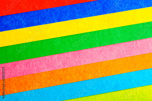 multicolored stripes at an angle from paperboard, abstract background, top view