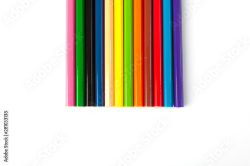 Color pencils lie on a white background