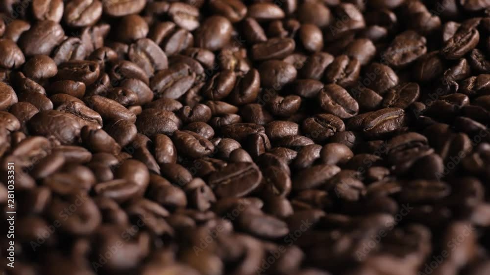 Roasted coffee bean. Fragrant coffee beans scrolls slowly around the camera. Slow Motion Close Up of Whole Roasted Coffee Beans. Roasted coffee bean. Fragrant coffee beans scrolls slowly around the camera. Slow Motion Close Up of Whole Roasted Coffee Beans.