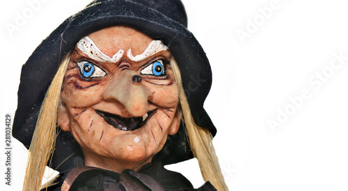 Photos portrait of an ugly witch doll with balck hat on white background