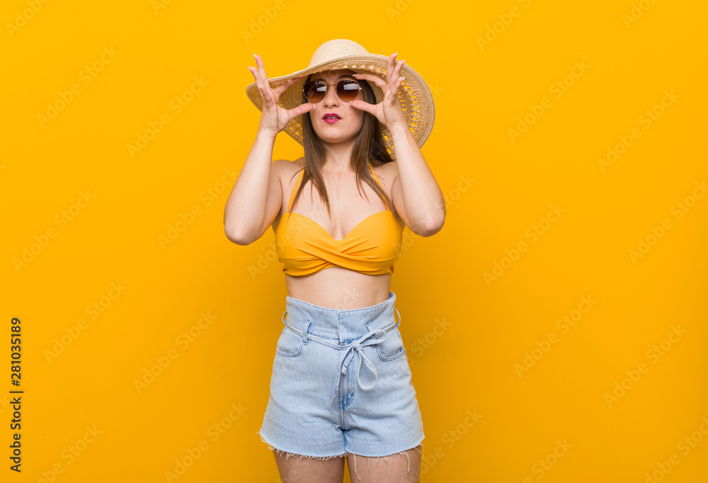 Young caucasian woman wearing a straw hat, summer look keeping eyes opened to find a success opportunity. Young caucasian woman wearing a straw hat, summer look keeping eyes opened to find a success opportunity.