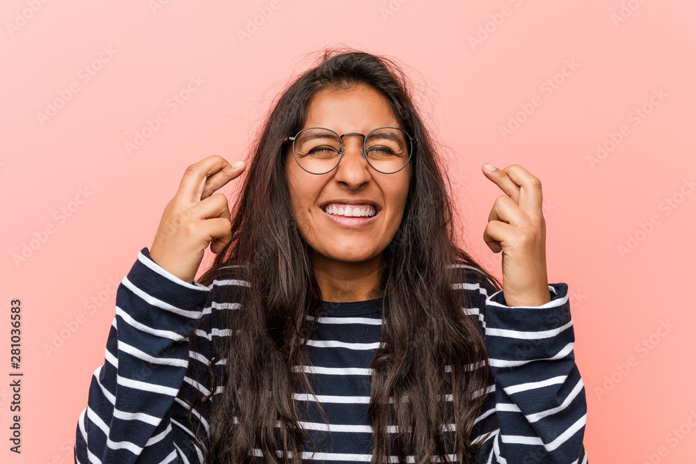 Young intellectual indian woman crossing fingers for having luck Young intellectual indian woman crossing fingers for having luck