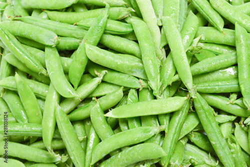 Fresh pea pods as background. Top view. © Nikolay