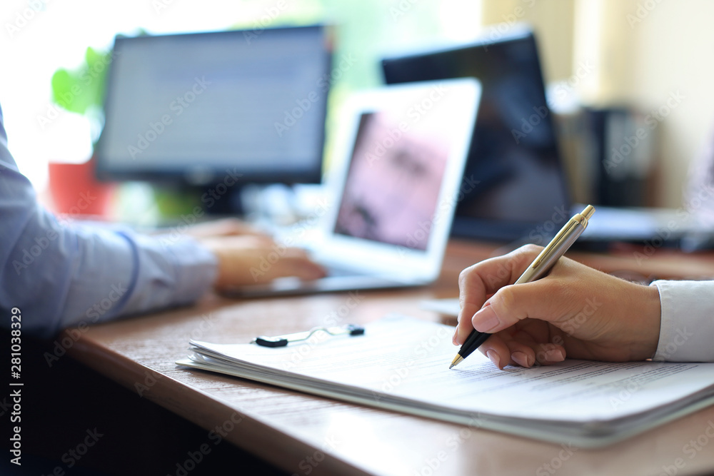 Business adviser analyzing financial figures denoting the progress in the work of the company. Business adviser analyzing financial figures denoting the progress in the work of the company.