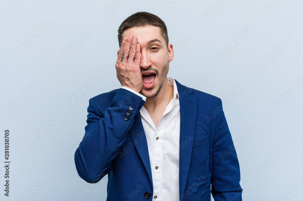 Young business caucasian man having fun covering half of face with palm. Young business caucasian man having fun covering half of face with palm.