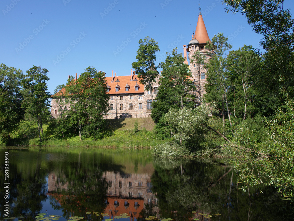 Cesvaine stone castle, beautiful summer day, pond, reflections, Latvia Cesvaine stone castle, beautiful summer day, pond, reflections, Latvia