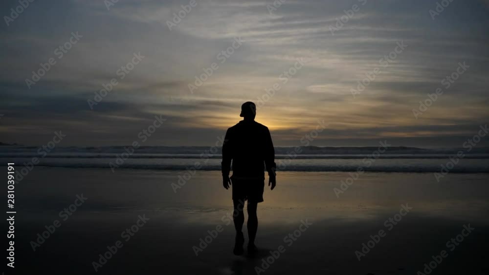 Man on beach at sunrise on the coast of California Man on beach at sunrise on the coast of California