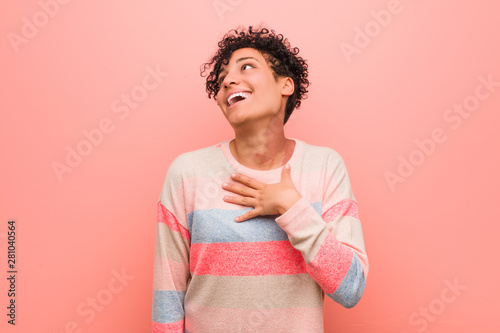 Fényképezés Young mixed african american teenager woman laughs out loudly keeping hand on chest