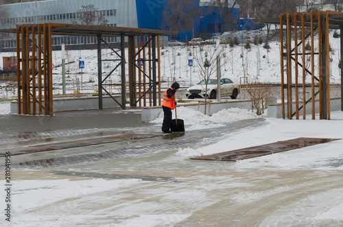 Wallpaper Mural An employee of public services in a signal vest removes snow with a shovel Torontodigital.ca