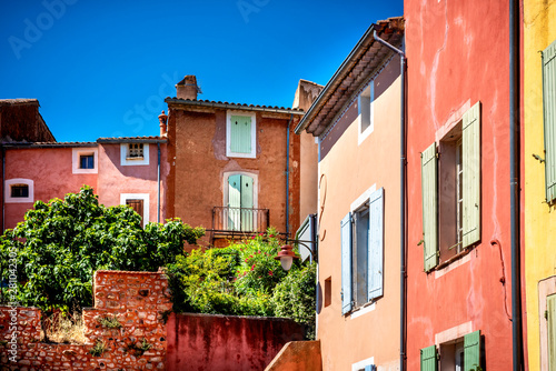 Fototapeta Naklejka Na Ścianę i Meble -  Roussillon: A narrow street in the beautiful French village of Roussillon, where the buildings are made with colorful, locally mined ochre. France