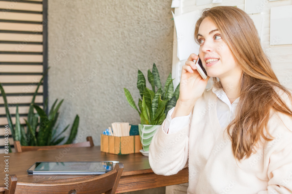Business woman with smartphone working in open office place Business woman with smartphone working in open office place