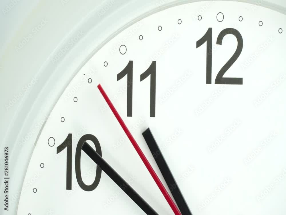 Closeup White wall clock face beginning of time 10.50 am or pm, Clock minute walk slowly, Time concept. Closeup White wall clock face beginning of time 10.50 am or pm, Clock minute walk slowly, Time concept.